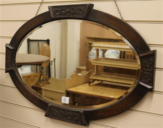 An oak frame wall mirror, W.87cm